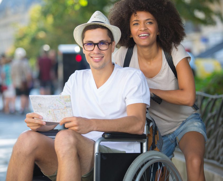 How Can Community Care Help Me - Couple on holiday, man in wheelchair